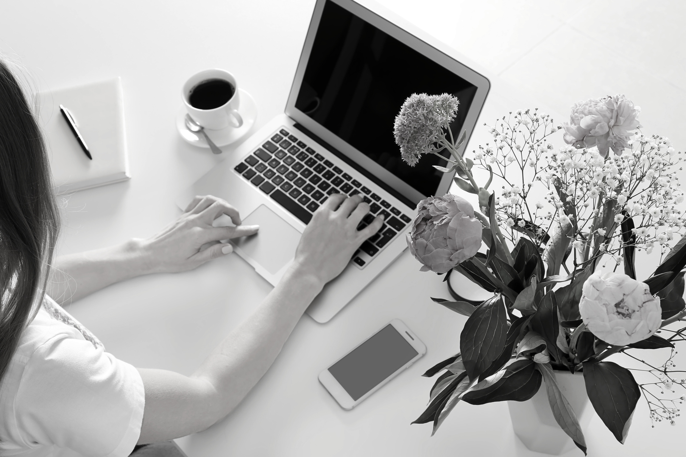 Woman Using Laptop at White Table